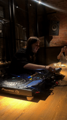 DJ performs while patrons drink at Moscow venue
