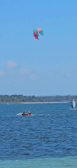 Sunny morning beach activities observed in Denpasar, Indonesia