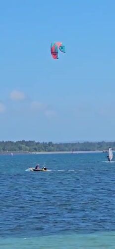 Sunny morning beach activities observed in Denpasar, Indonesia