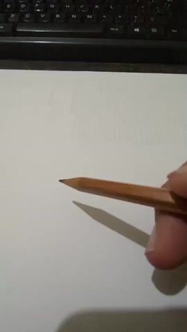 A hand holding a pencil is drawing the word HELP on a piece of paper. The paper is on a desk in front of a keyboard. The pencil is brown and has a sharp point. The letters are drawn in cursive.