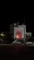 Illuminated domed building observed at night in Lhokseumawe, Indonesia