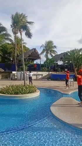 Resort staff perform synchronized poolside entertainment in Venezuela