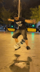 Young skateboarders perform nighttime tricks in public plaza