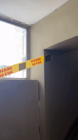 Caution tape blocks a wall opening in Caracas