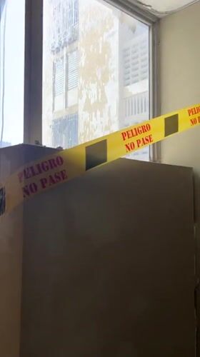 Caution tape blocks a wall opening in Caracas