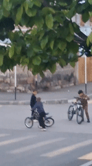 Young people gather with bicycles at Gyumri crosswalk