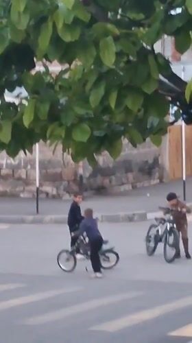 Young people gather with bicycles at Gyumri crosswalk