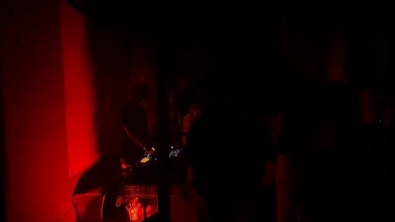 Early morning DJ set captured in red-lit Mexico City room
