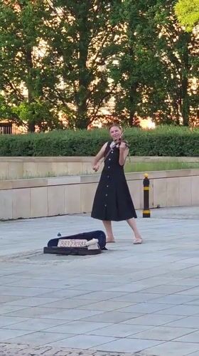 Street performers and summer crowds fill Warsaw's historic center
