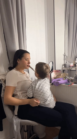 Woman holds child on chair in Russian town
