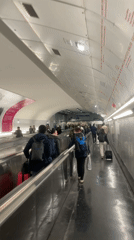Rush hour pedestrians navigate Paris underground transit walkway