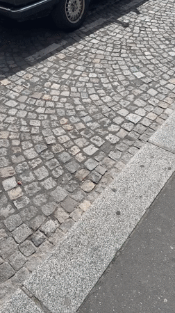Group gathers with BMW convertible on Paris cobblestone street