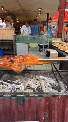 Street vendor roasts whole pig over charcoal in Nha Trang