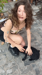 Woman plays with small dog in Đà Nẵng streets