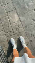 Person in grey sneakers filmed on paved surface in Thailand