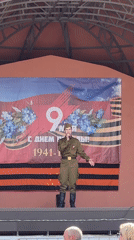 Military-uniformed performer entertains crowds at outdoor carnival event