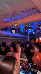 Female DJ entertains diverse crowd at Paris nightclub