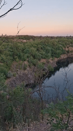 Quarry lake and railway viaduct at dusk, Kryvyi Rih