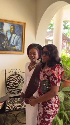 Women photographed near saxophone artwork in Bar Jirgi Summa