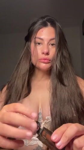 Woman applies lip gloss in Kiryat Bialik beauty moment