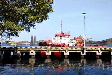 Harbor, market stalls, and a landmark monument in Pare-Pare