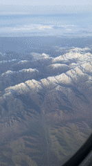Passenger captures aerial mountain views during Kazakhstan flight