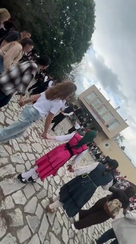 Traditional circle dance performed in Bulgarian village square