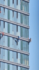 Window cleaners work the exterior of a Moscow glass skyscraper