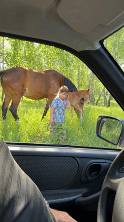 Girl rides bareback on horse through rural Russian village
