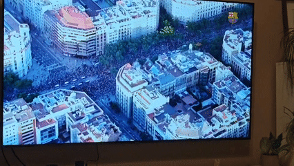 Sofia resident watches TV coverage of large public celebration