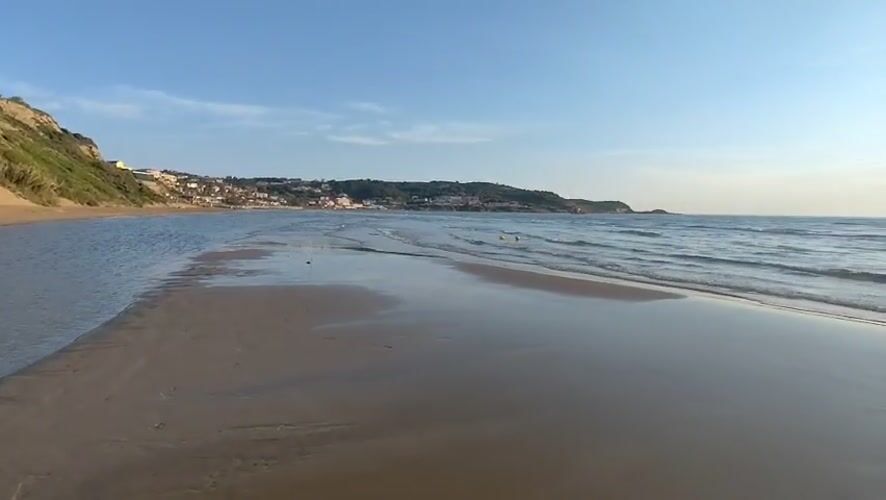 Sunset beach walk with dog captured in Agios Stefanos