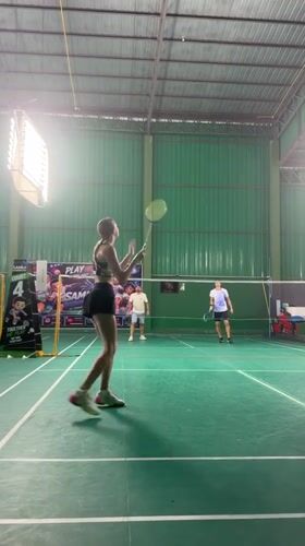 Indoor badminton in session at a Ko Samui sports facility