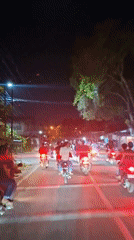 Group rides motorcycles through Lhokseumawe streets at night