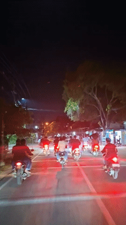Group rides motorcycles through Lhokseumawe streets at night
