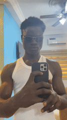Man takes selfies indoors in Badagry, Nigeria