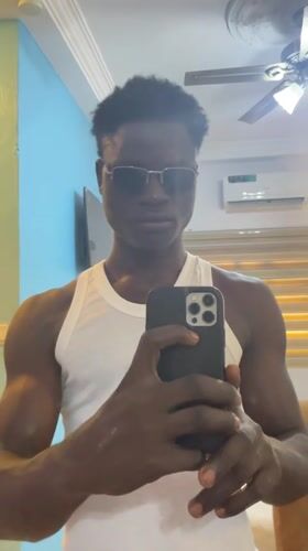 Man takes selfies indoors in Badagry, Nigeria