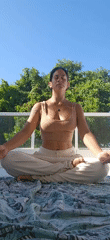 Woman practices outdoor meditation in Tamoios, Brazil