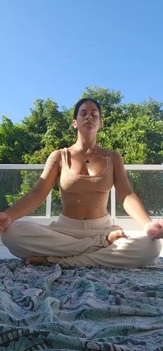 Woman practices outdoor meditation in Tamoios, Brazil