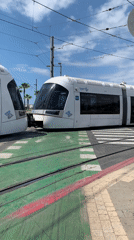 Light rail tram crosses urban intersection in Tel Aviv