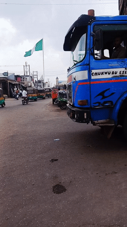 Crane truck operates on busy Jos street