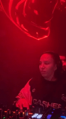 Female DJ performs at Moscow nightclub with dancing crowds