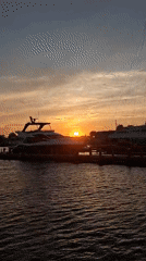 Nantucket Harbor at golden hour, ferries and sailboats docked