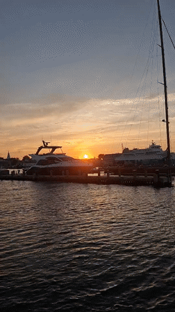 Nantucket Harbor at golden hour, ferries and sailboats docked
