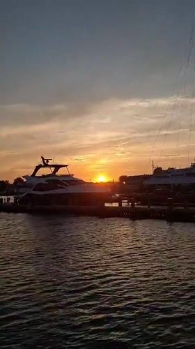 Nantucket Harbor at golden hour, ferries and sailboats docked
