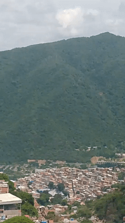 Caracas hillside barrio, rooftops and mountains up close