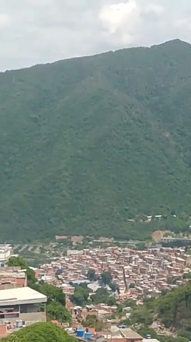 Caracas hillside barrio, rooftops and mountains up close