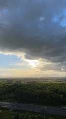 Dramatic storm clouds over Russian highway and forest landscape