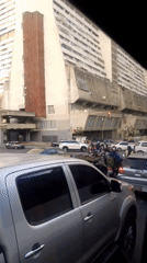 Evening traffic flows through Caracas streets amid urban skyline