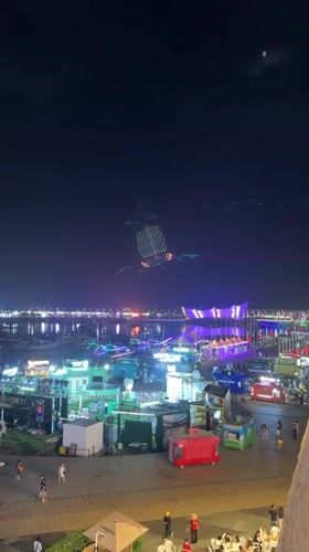 Drone sailboat lights up Qingdao's waterfront during busy summer night