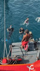 Divers in the water off Ko Tao on a calm morning